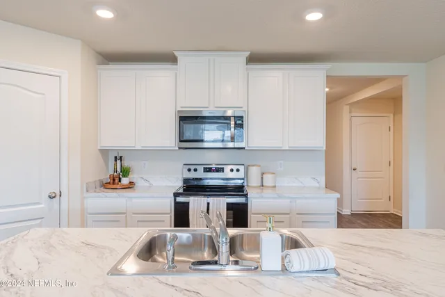 a kitchen with a sink a stove and refrigerator