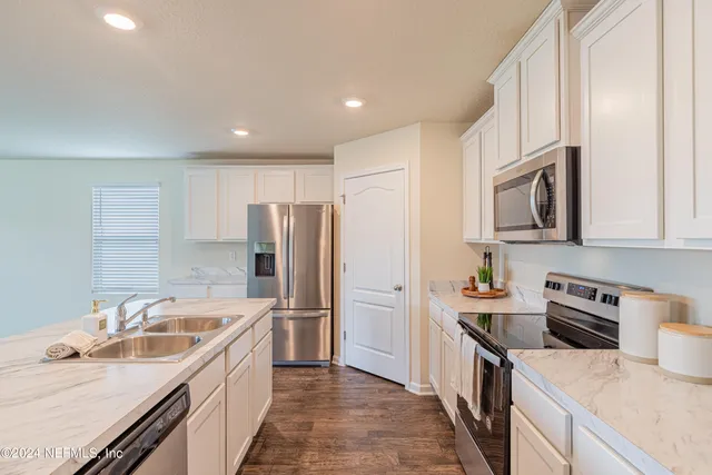a stove top oven sitting inside of a kitchen