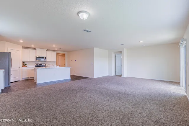 a kitchen with stainless steel appliances sink stove refrigerator and cabinets