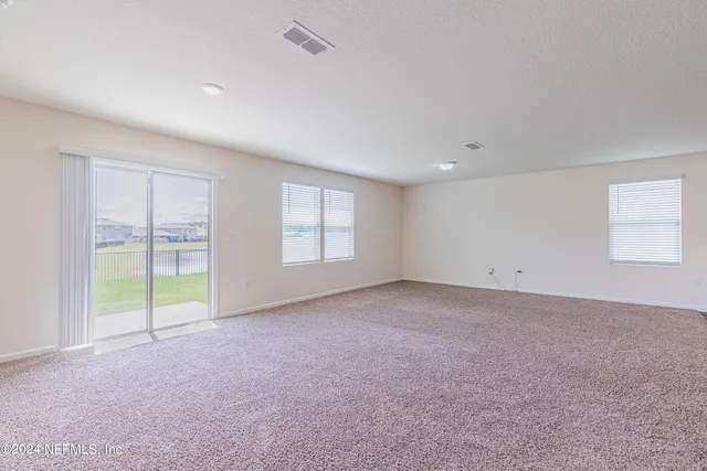 a view of a kitchen with a sink and a refrigerator