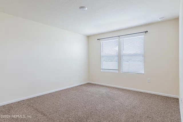 a view of a kitchen with a sink and a refrigerator