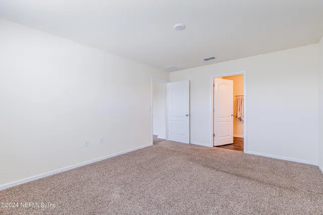 a view of kitchen with kitchen island a sink wooden floor and refrigerator