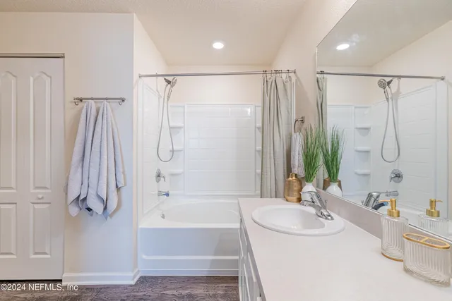 a bathroom with a glass shower door