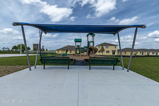 a view of a lake with houses in the background