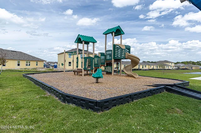 a view of a patio with table and chairs potted plants and floor to ceiling window