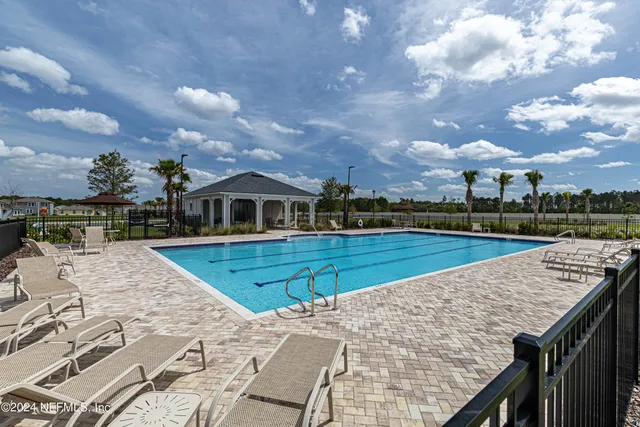 an aerial view of a house with a garden and lake view