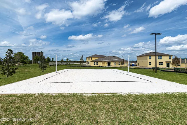 a view of swimming pool that has lawn chairs with wooden floor