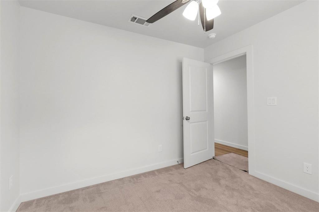 312 East Shepherd Street, Unit 312 Denison, TX 75021 - Photo 9 of 15 an empty room with a ceiling fan and a window