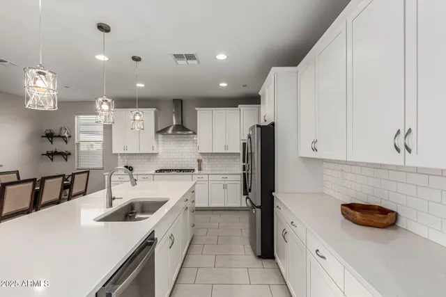 a kitchen with a sink a stove and cabinets