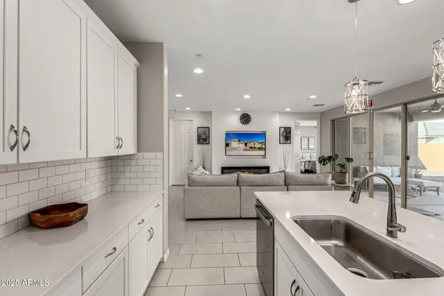 a kitchen with stainless steel appliances a sink a stove and cabinets
