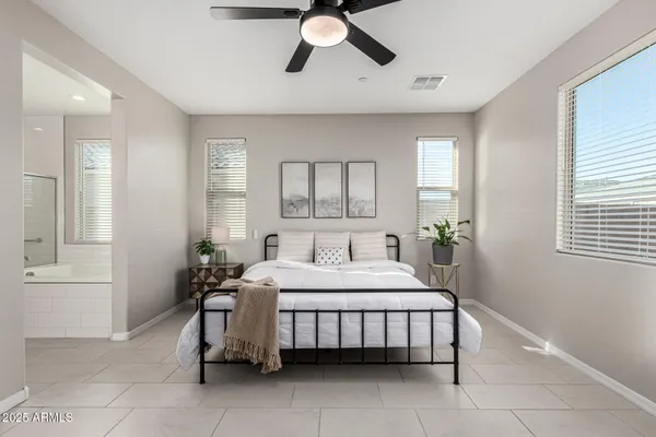 a bedroom with a bed and a chandelier