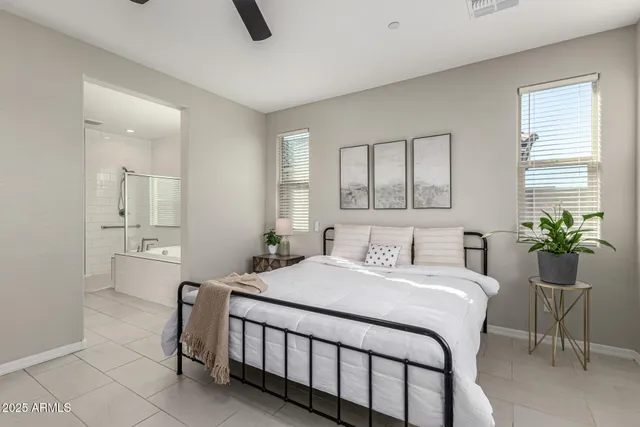 a bedroom with a bed a table and chair