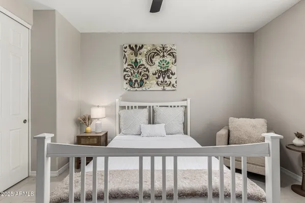 a bedroom with a bed and lamp