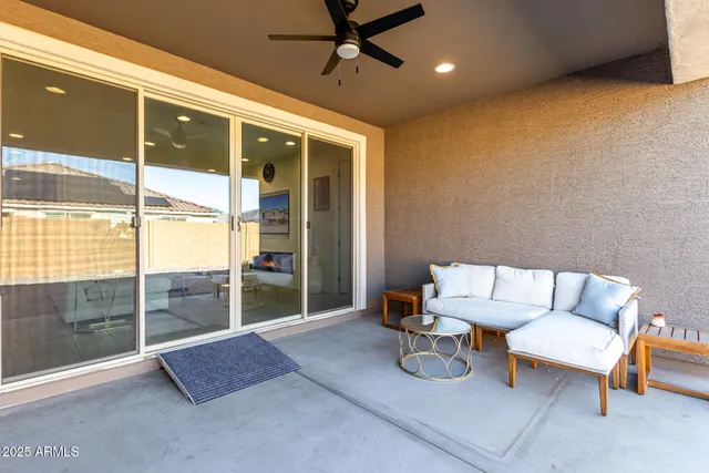 a living room with furniture and a floor to ceiling window