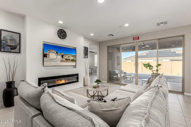 a living room with furniture and a flat screen tv with wooden floor