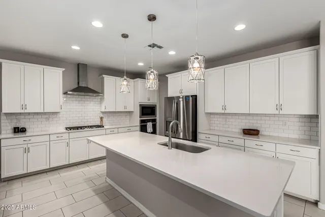 a kitchen with a sink refrigerator and cabinets