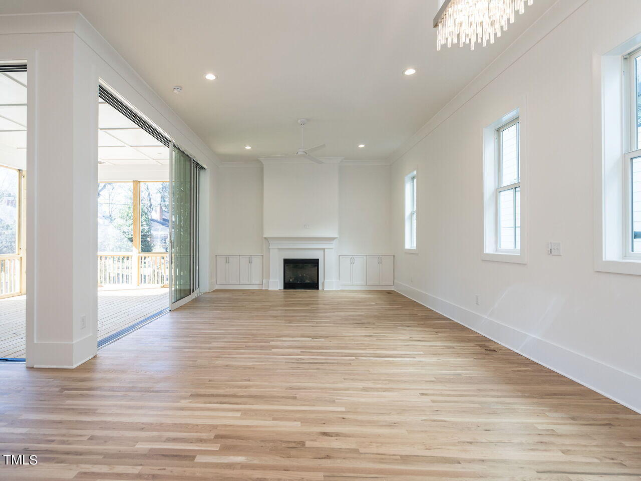 301 Shepherd Street Raleigh, NC 27607 - Photo 11 of 37 an empty room with wooden floor and windows
