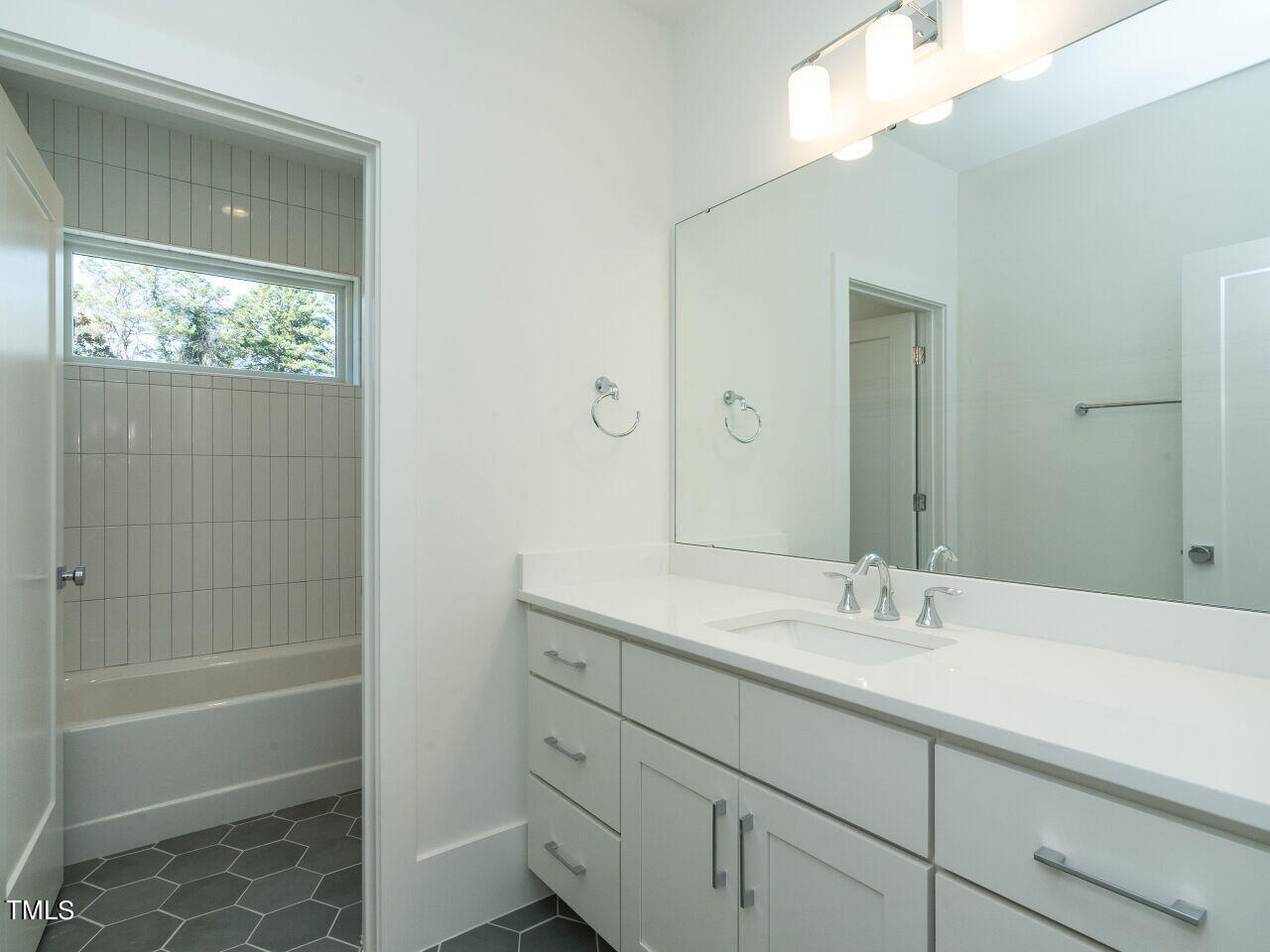 301 Shepherd Street Raleigh, NC 27607 - Photo 33 of 37 a bathroom with a shower sink and mirror