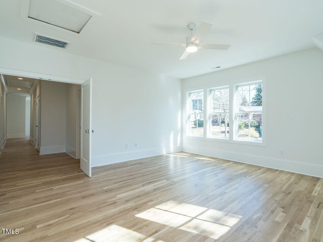 301 Shepherd Street Raleigh, NC 27607 - Photo 35 of 37 an empty room with wooden floor and windows