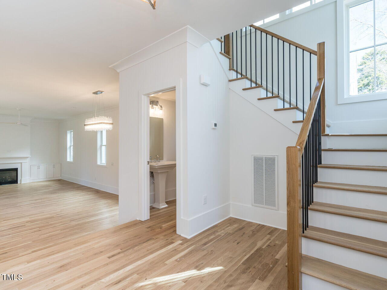 301 Shepherd Street Raleigh, NC 27607 - Photo 9 of 37 a view of entryway with wooden floor and stairs