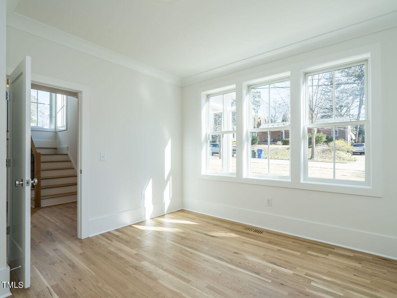 301 Shepherd Street Raleigh, NC 27607 - Photo 10 of 37 an empty room with wooden floor and windows