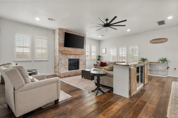 a kitchen with stainless steel appliances kitchen island a large island in the center and wooden floor