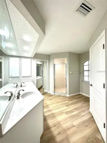 a spacious bathroom with a tub sink and mirror