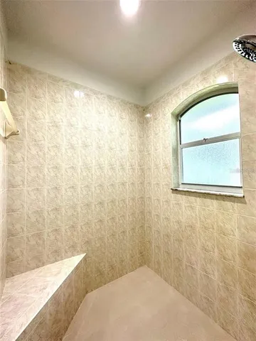 a bathroom with a bathtub and shower