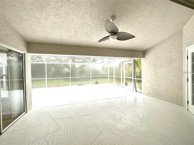 a view of an empty room with a balcony and large window