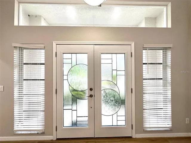 a front view of a house with large windows