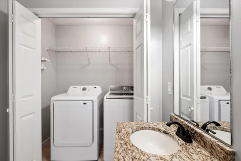 a bathroom with a sink and a washing machine