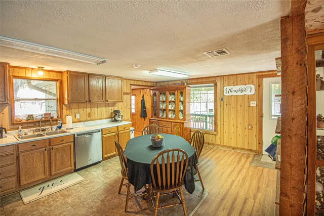a large dining space with furniture window and wooden floor