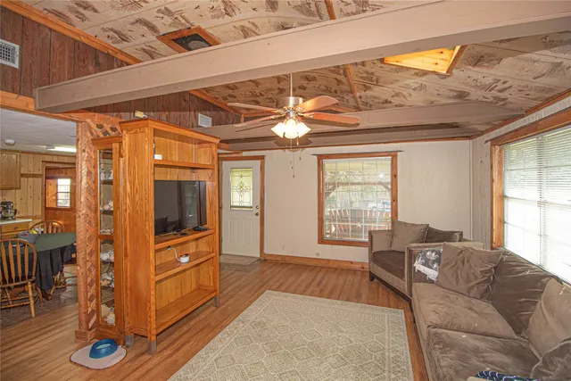 a living room with furniture and large windows