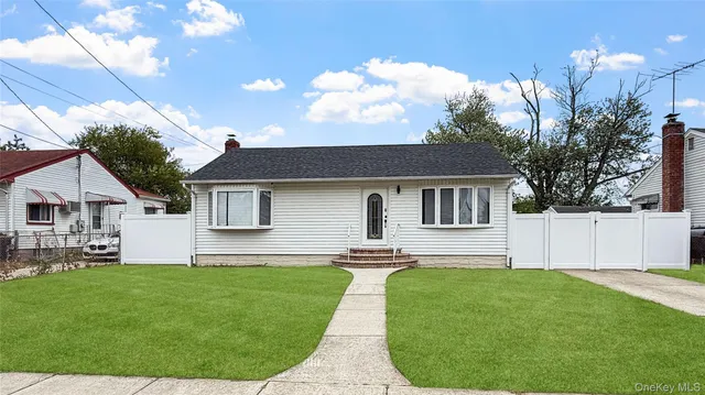 a front view of house with a garden and patio