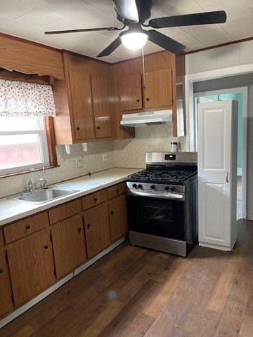 23 Plumer Street Everett, MA 02149 - Photo 14 of 29 a kitchen with stainless steel appliances granite countertop a stove a sink and a microwave