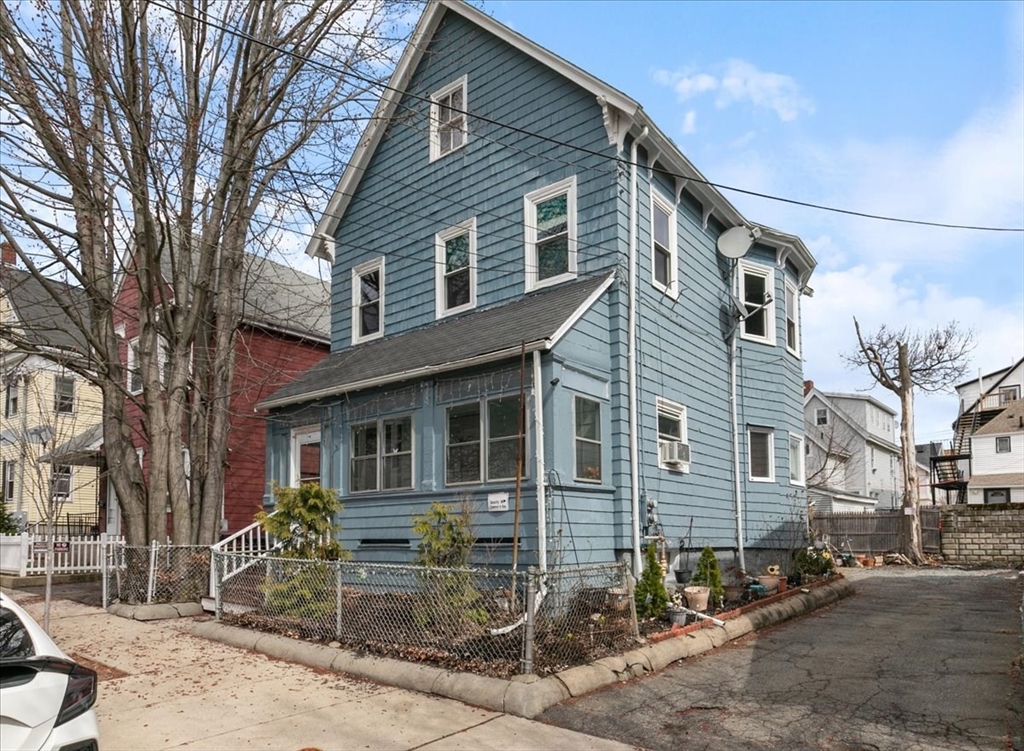 23 Plumer Street Everett, MA 02149 - Photo 24 of 29 a front view of a house with garden and trees