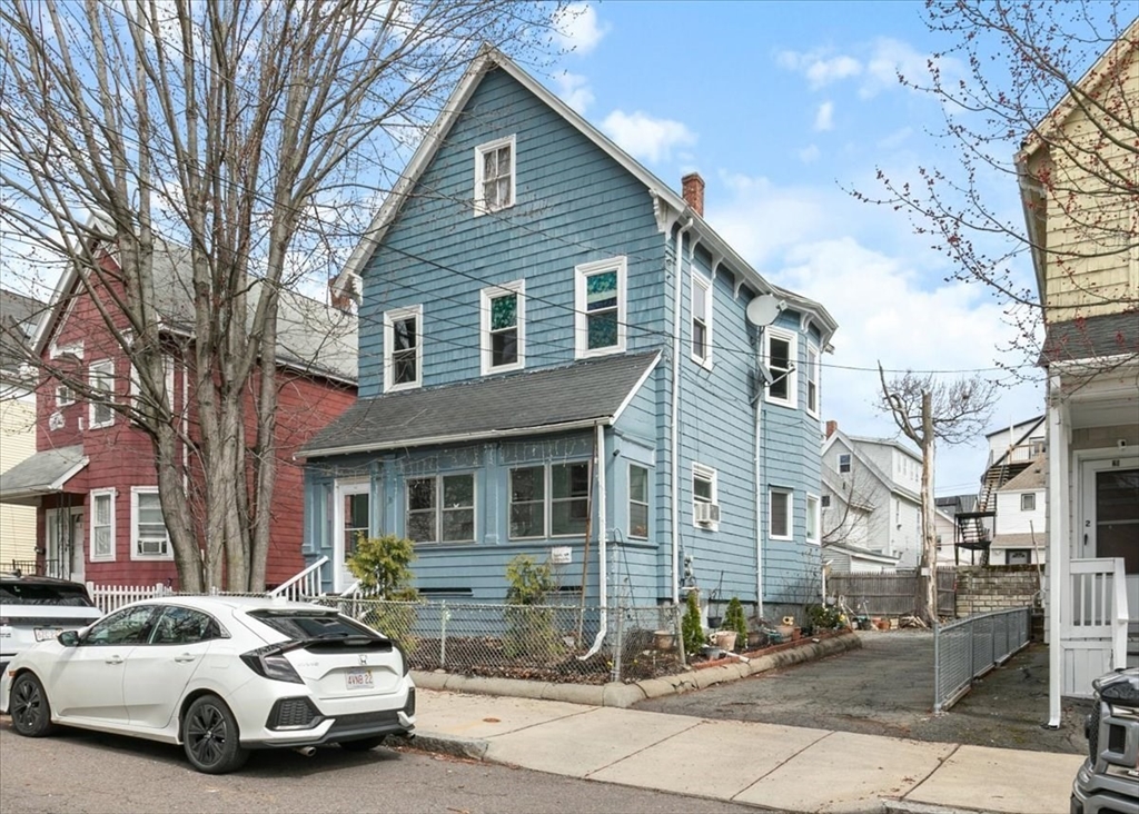 23 Plumer Street Everett, MA 02149 - Photo 27 of 29 a car parked in front of a white house