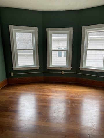 23 Plumer Street Everett, MA 02149 - Photo 4 of 29 a view of a small space with wooden floor and a window