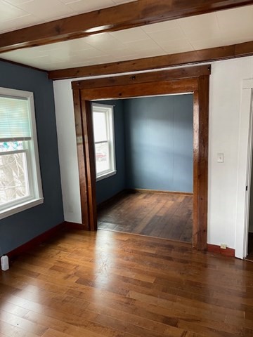 23 Plumer Street Everett, MA 02149 - Photo 7 of 29 an empty room with wooden floor and windows