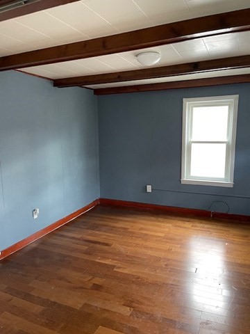23 Plumer Street Everett, MA 02149 - Photo 8 of 29 a view of empty room with wooden floor and fan