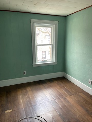 23 Plumer Street Everett, MA 02149 - Photo 9 of 29 an empty room with wooden floor and windows