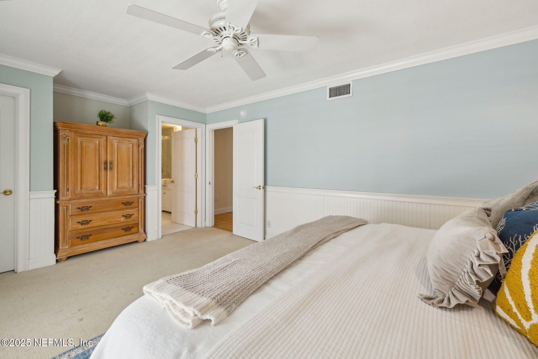2233 Seminole Road, Unit 10 Atlantic Beach, FL 32233 - Photo 26 of 63 a bedroom with a bed and a chandelier