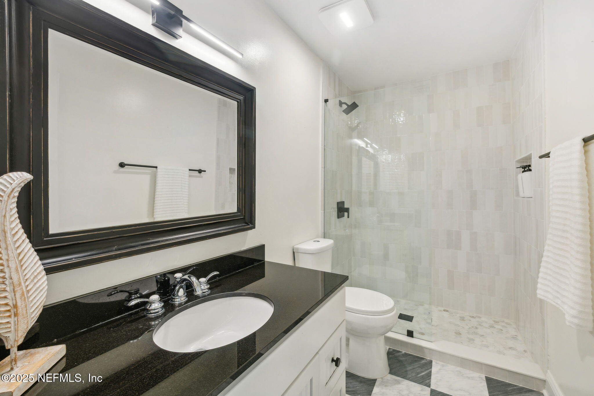 2233 Seminole Road, Unit 10 Atlantic Beach, FL 32233 - Photo 33 of 63 a bathroom with a granite countertop sink toilet a mirror and shower
