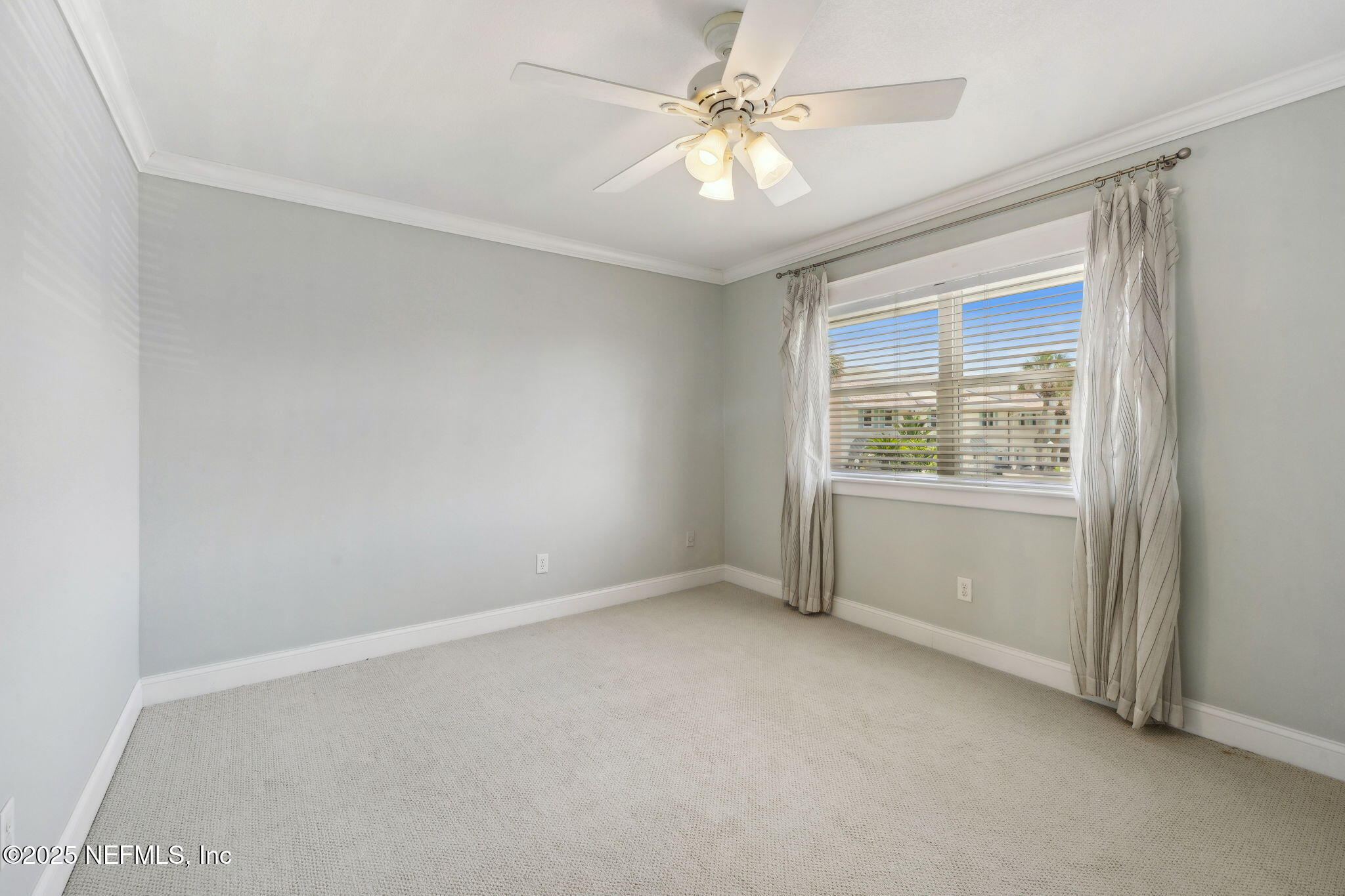 2233 Seminole Road, Unit 10 Atlantic Beach, FL 32233 - Photo 35 of 63 an empty room with a window and a fan