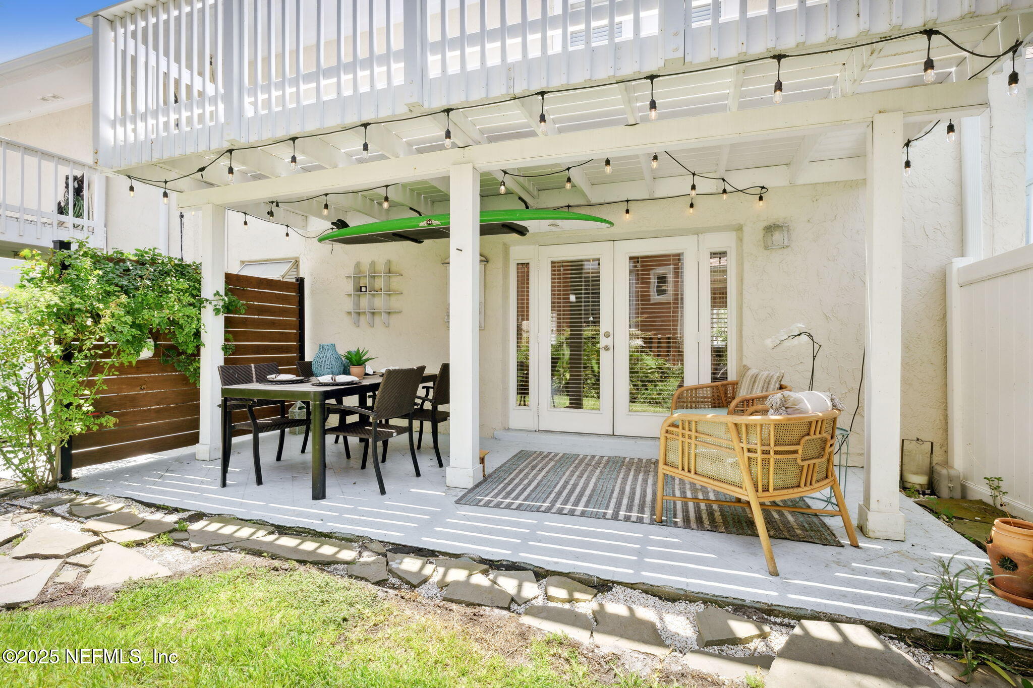 2233 Seminole Road, Unit 10 Atlantic Beach, FL 32233 - Photo 37 of 63 a view of a patio with a table and chairs and potted plants