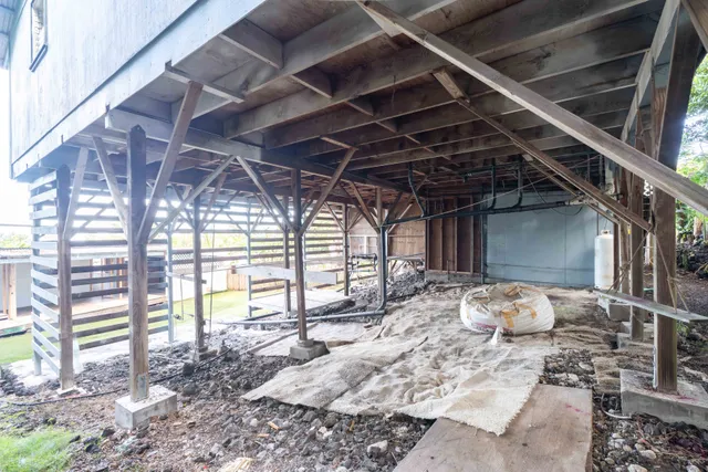 a view of a room with wooden walls and a window