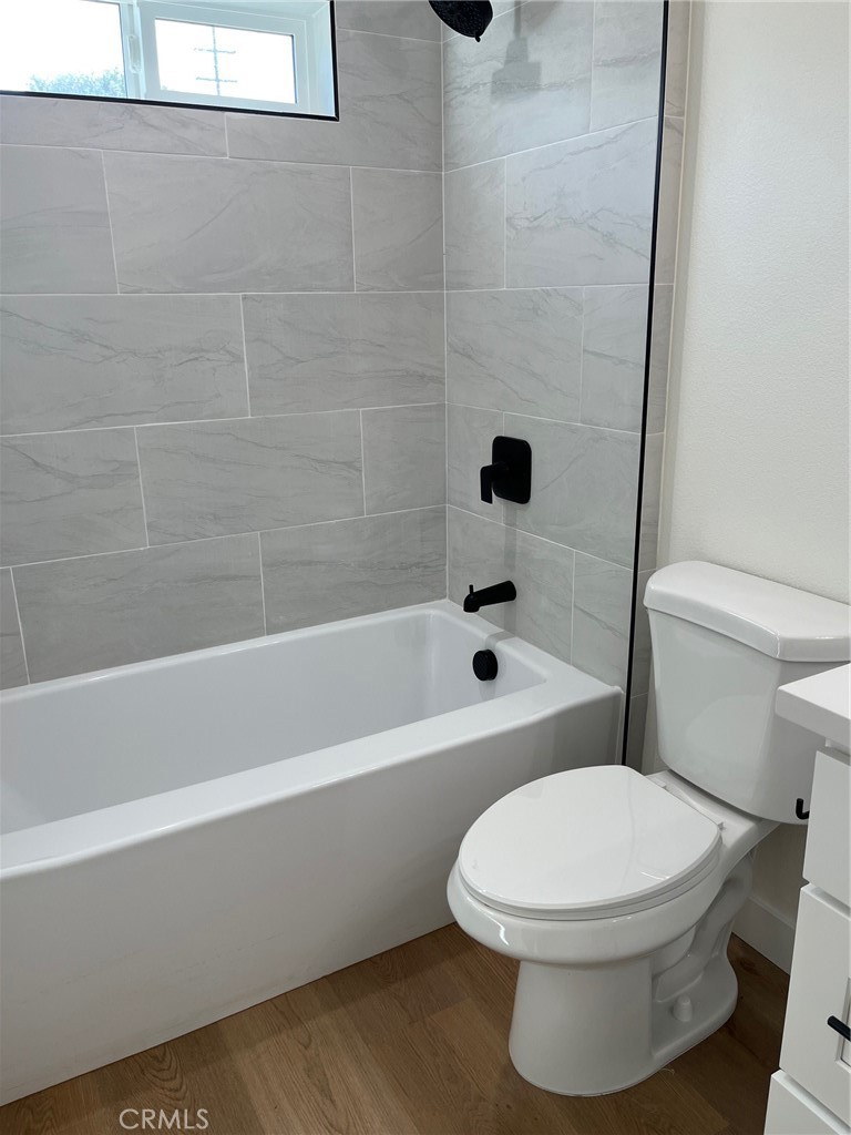 504 East Stuart Avenue, Unit 2 Redlands, CA 92374 - Photo 13 of 22 a white toilet and tub sitting next to a bathroom sink