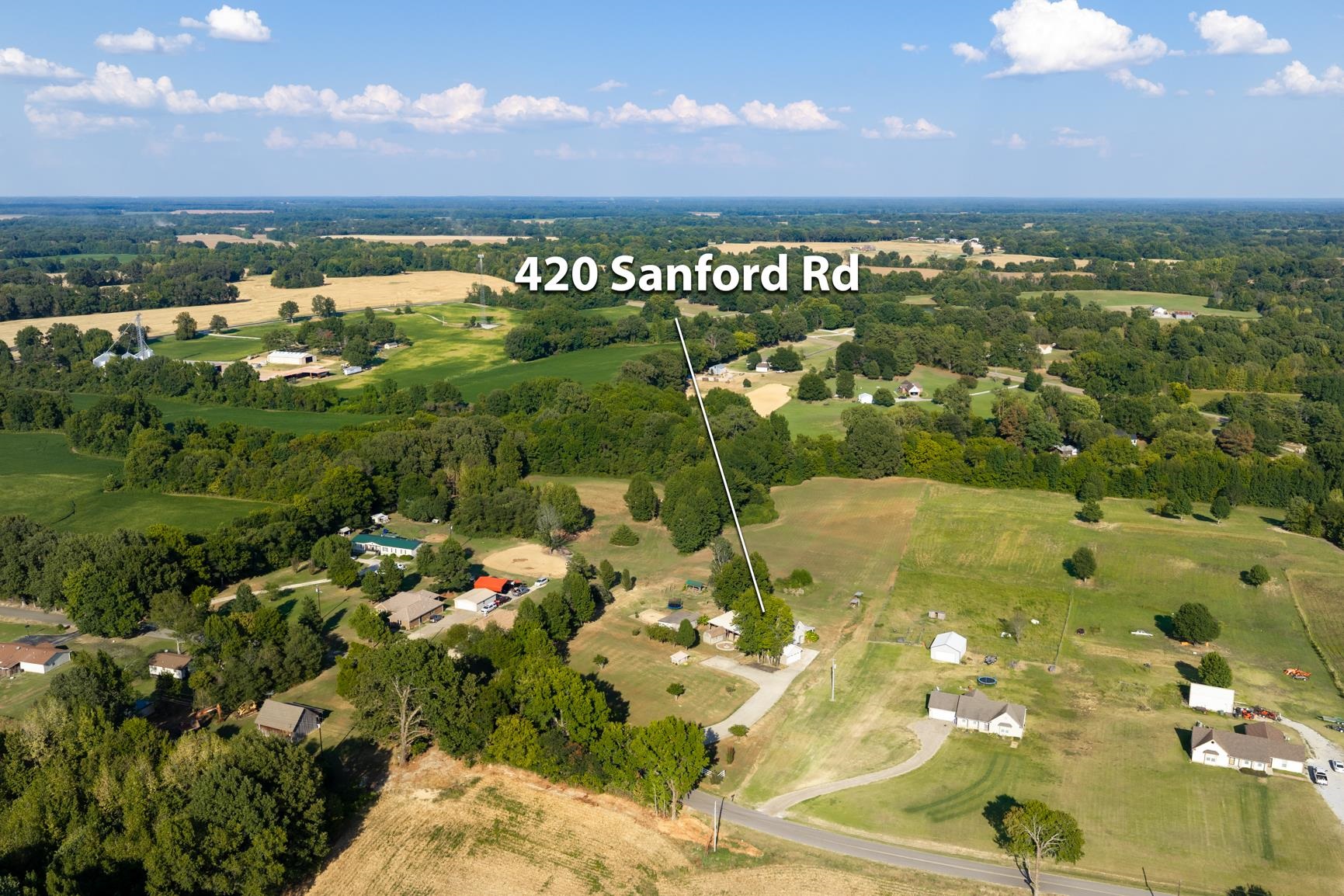 420 Sanford Road Covington, TN 38019 - Photo 25 of 27 Expansive property featuring a residence, detached buildings, and surrounding undeveloped land