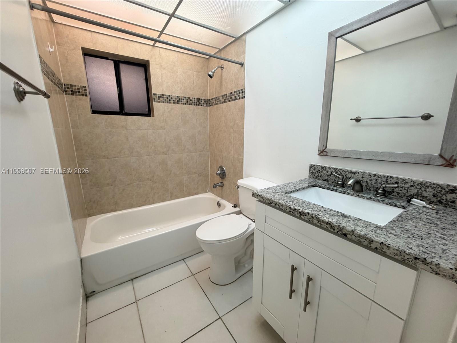 8760 Southwest 133rd Avenue Road, Unit 217 Miami, FL 33183 - Photo 5 of 10 a bathroom with a granite countertop sink toilet and shower