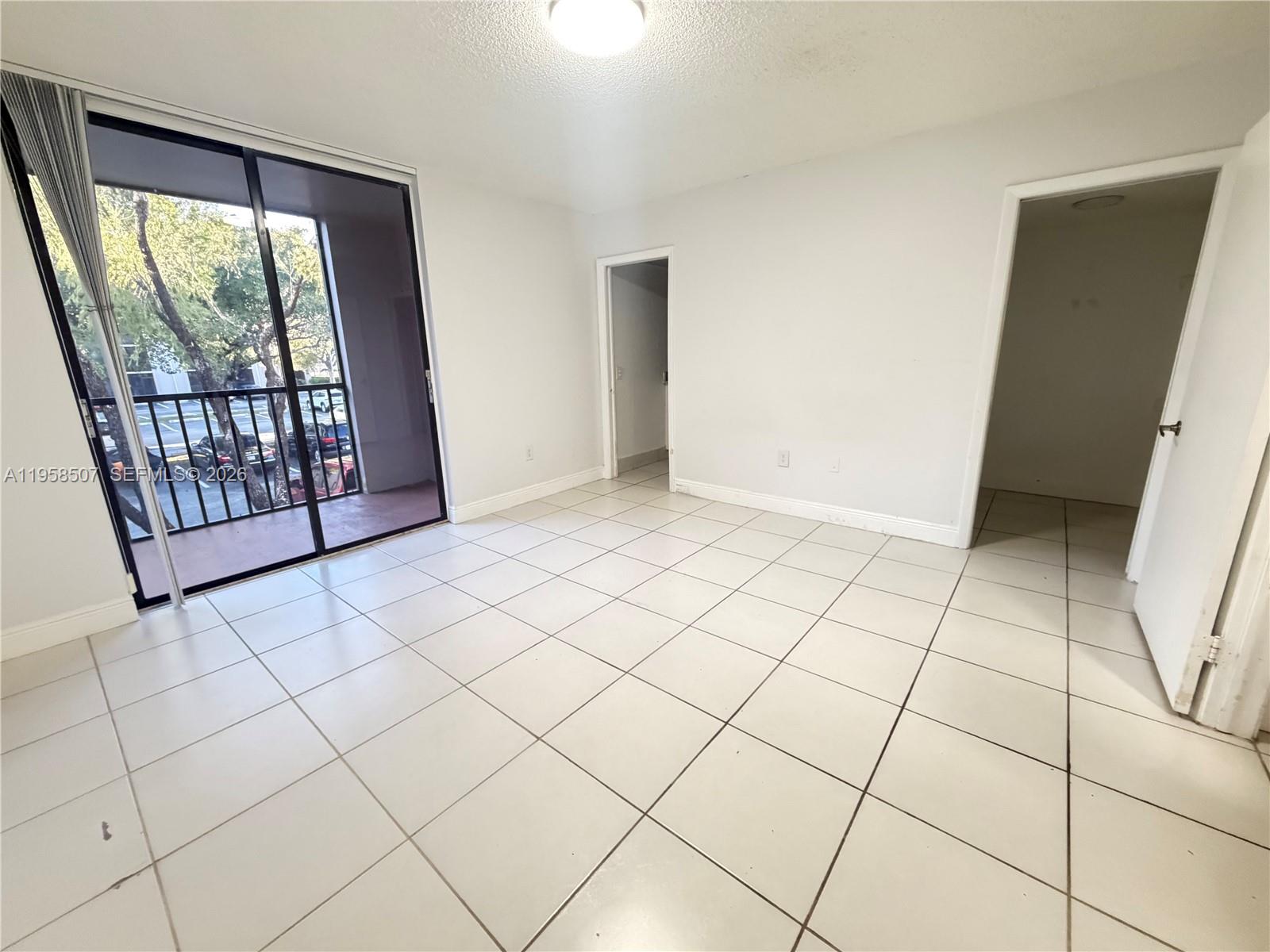 8760 Southwest 133rd Avenue Road, Unit 217 Miami, FL 33183 - Photo 7 of 10 a view of an empty room and window